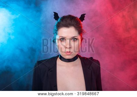 Halloween, Holidays And Carnival Concept - Vamp Woman In Jacket And With Bat Ears In Gothic Style.