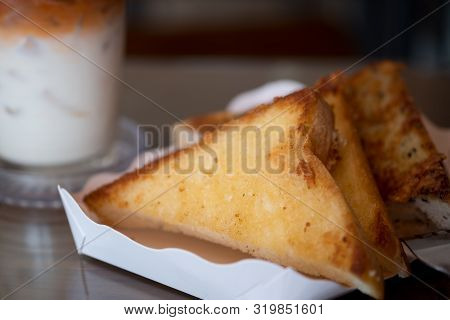 Three Piece Of Triangle Of Garlic Bread In White Paper Tray