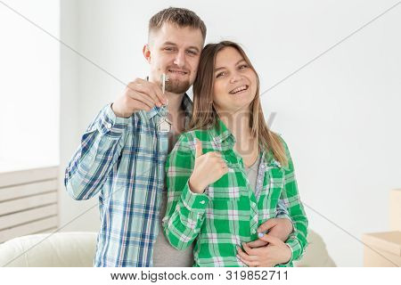 Young Married Couple With Boxes And Holding Flat Keys.
