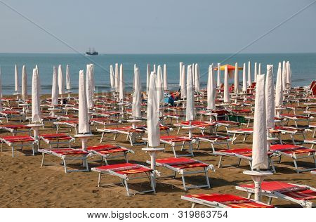 Many Parasol And Deckchairs  On The Sandy Beach Of The Resort In Summer