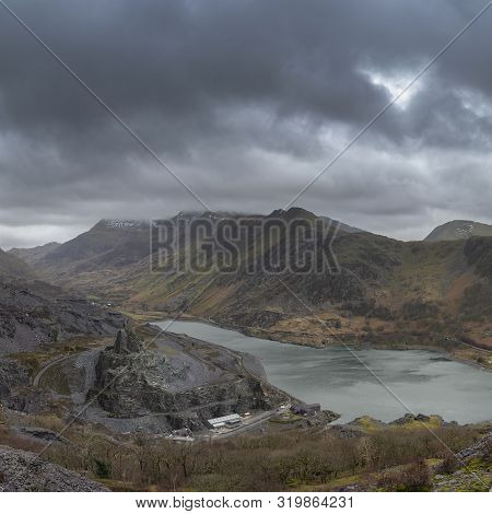 Stunning Landscape Image Of Dinorwig Slate Mine And Snowcapped Snowdon Mountain In Background During