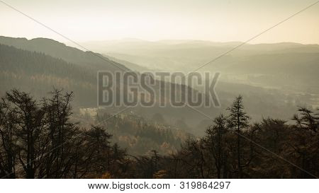 Landscape View From Gummers How In Lake District Over Beautiful Autumn Fall Color Forest With Hazy U