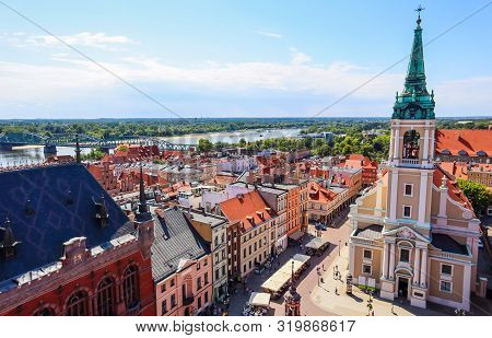 Aerial View Of The Vistula ( Wisla ) River With Bridge And Historical Buildings Of The Medieval City