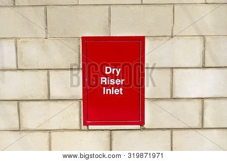 Dry Riser Inlet Box Red On Brick Wall For Emergency Fire Services Water Connection For Hose Brigade 