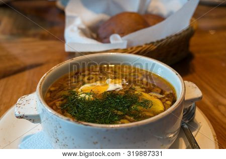 Borscht Or Borsht Rassolnik Soup In A Rustic Bowl Garnished With Sour Cream And Dill