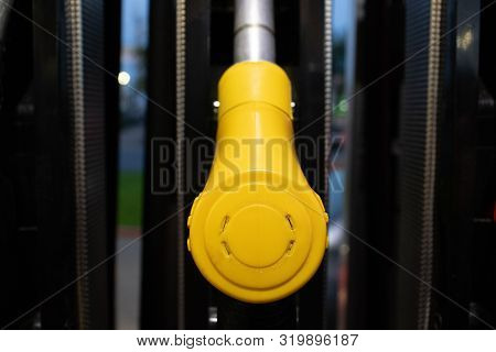Yellow Gun For Refueling The Car At The Refueling Position