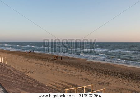 Thew View Of People Walking On A Beach. Tyrrhenian Sea.