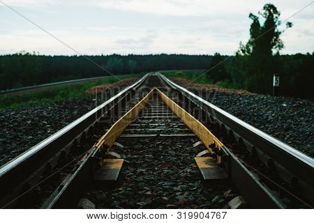 Dramatic Scenery With Railway In Perspective And Turn. Journey On Rail Track. Sleepers And Rails Clo