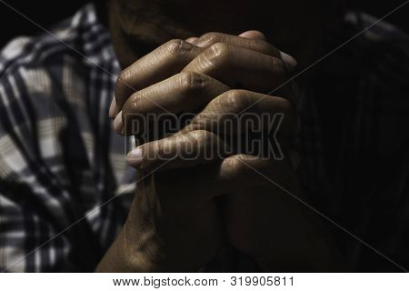 Hand Of Man While Praying For Religion. Concept Peace And Life.