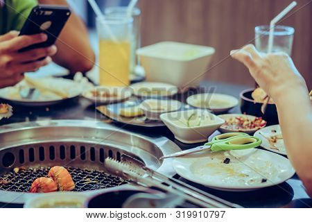 People Grilling Meat On A Smokeless Barbecue Grill In A Restaurant. Selective Focus On Shrimps.