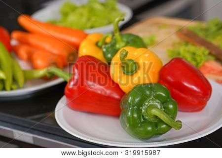 Colored Sweet Peppers On Desk In Ketchen