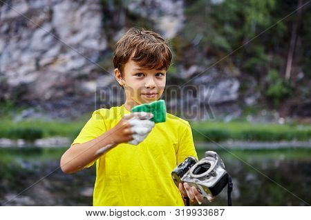 The Boy Cleans A Digital Camera Sensor.