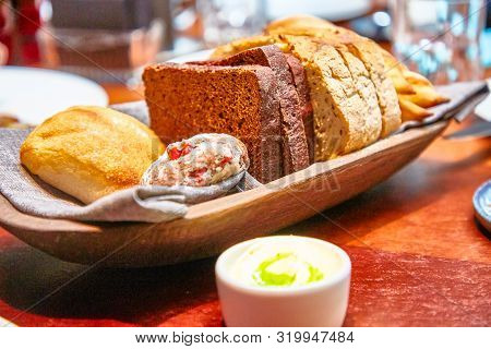 Basket With Different Bread On The Table In The Restaurant