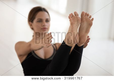 Woman Doing Paripurna Navasana Exercise, Practicing Yoga, Feet Close Up
