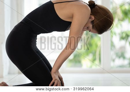 Young Woman Practicing Yoga, Doing Uddiyana Bandha Exercise