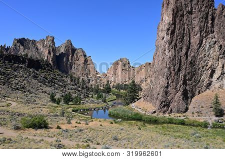 Smith Rock State Park And Crooked River Near Town Of Terrebonne, Oregon On Cloudless Summer Day.