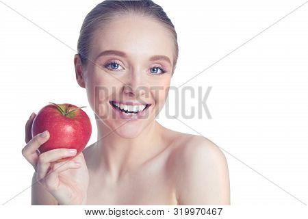 Portrait Of Happy Smiling Young Beautiful Woman Eating Red Apple, Over White Background