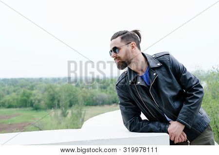 Side View Fashion Portrait Of Thinking Stylish Young Handsome Bearded Hipster Man In Sunglasses Look