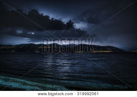 Thunderstorm Over The Mountains Of Piedmont And Major Lake In Foreground In The End Of Summer
