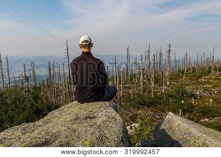 Young Man Tourist Sittiing On Top Of Mountain, Sumava National Park And Bavarian Forest, Czech Repub