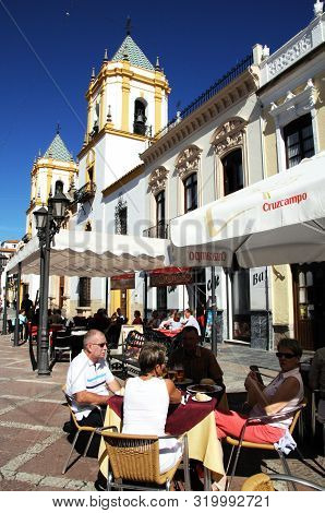 Ronda, Spain - October 24, 2009 - Tourists Relaxing At Pavement Cafes In The Plaza Socorro With The 