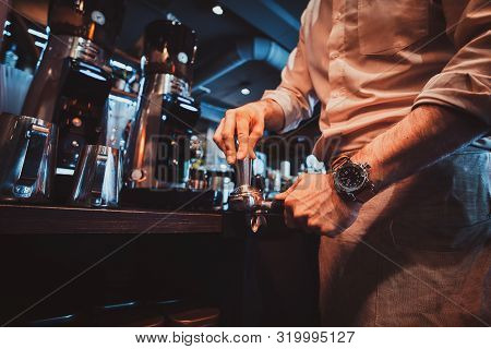 Talanted Barista Is Prepairing Coffee For Clients At Posh Restaurant Using Coffee Machine.
