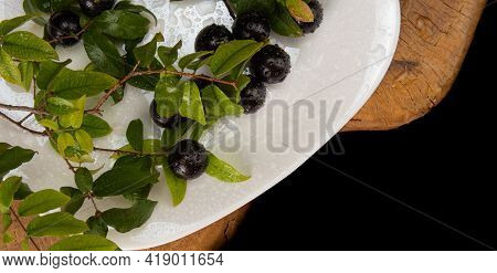 Jabuticaba, Jabuticabas In Detail Inside A White Plate With Branches And Leaves On Rustic Wood, Top