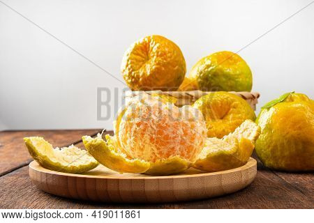Orange Ponkan, Orange Ponkan In A Basket On Rustic Wooden Light Background, Selective Focus.