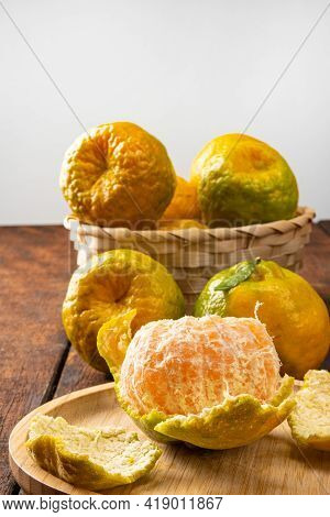 Orange Ponkan, Orange Ponkan In A Basket On Rustic Wooden Light Background, Selective Focus.