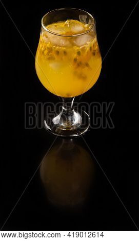 Brazilian Drink, Sake Caipirinha With Passion Fruit In A Bowl, On A Reflective Black Surface, Black
