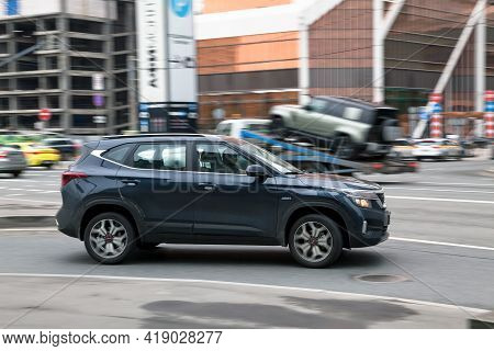 Fast Moving Blue Kia Seltos Suv Rides On A City Road. A Car On Street In Motion. Overspeed In City C