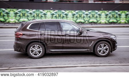 Bmw X3 Is The Third Generation Of German Crossover. Brown Disty Suv Rides On Street On High Speed. S