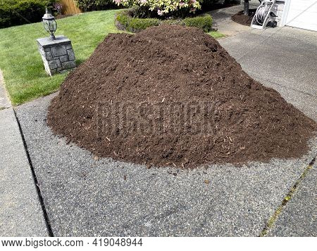 Pile Of Fresh Topsoil Dirt In Home Driveway For Lawn Maintenance