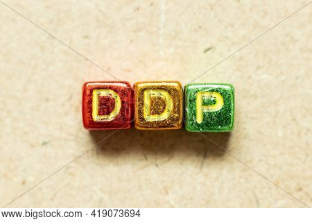 Metallic Color Alphabet Letter Block In Word Ddp (abbreviation Of Delivered Duty Paid) On Wood Backg