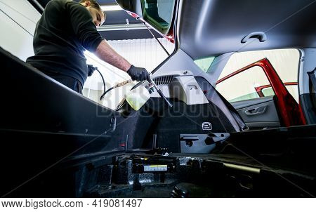 A Car Service Worker Cleans Interiror With A Special Foam Generator