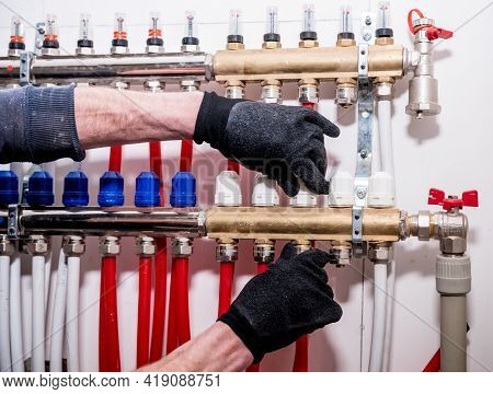Pipefitter Install System Of Underfloor Heating System At Home