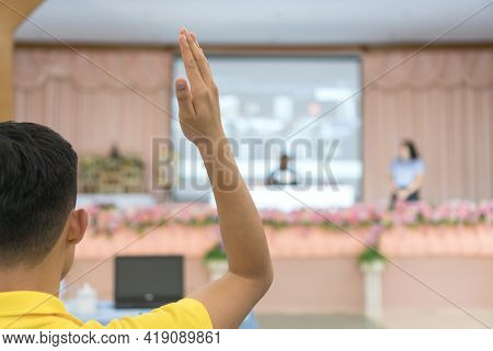Audience Or Students Raising Hands Up At Conference To Answer Question While Speaker Speech At Semin