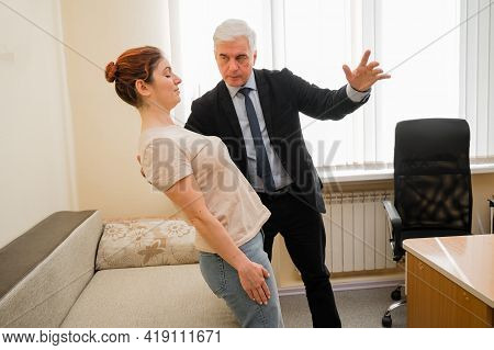 Mature Gray-haired Man Hypnotizes Caucasian Woman During Hypnotherapy Session. The Psychologist Uses