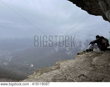 Guamka, Russia April 17, 2021: Tourists On Huge Cliff With Spectacular View Of Nature. Group Of Peop