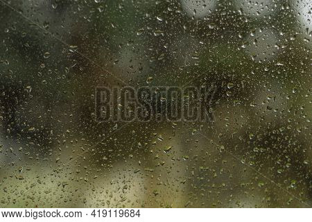 Raindrops On The Glass Window As A Background. Close-up