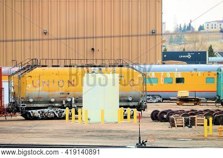 April 26, 2021 In Cheyenne, Wy:  Union Pacific Rail Yard Including A Vintage Passeneger Rail Car Bey