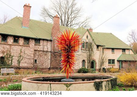 April 26, 2021 In Denver, Co:  Chihuly Glass Art Sculpture On A Courtyard In Front Of An Elegant Man