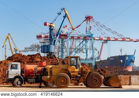 Container Terminal Of Tis Group Dry Cargo Port. Construction Truck And Volvo Heavy Bulldozer On Port