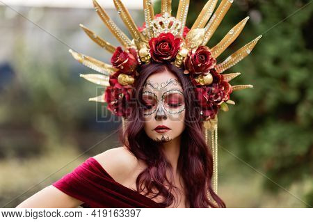 Young Woman With Painted Skull On Her Face For Mexico's Day Of The Dead.