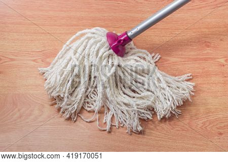 Bottom Working Part Of Classic Yarn Mop In The Form Of Bundle Of Cotton Rope Segments On A Wooden Fl