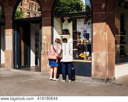 Strasbourg, France - Sep 22, 2017: Rear View Of Two Unrecognizable Women Looking At The Large Showca
