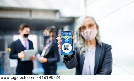 Senior Woman Showing Smartphone With Covidpass, Coronavirus, Travel And New Normal.