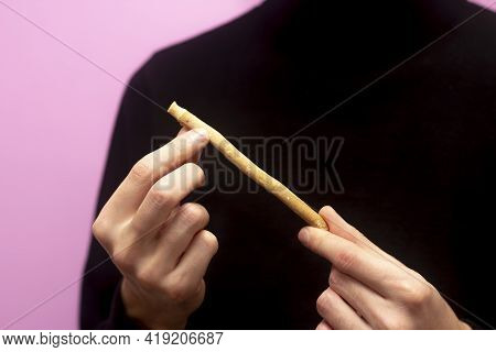 Guy Hold Miswak. Bokeh Effect. Teeth Cleaning. Sunnah. Sivak. Pink Background.