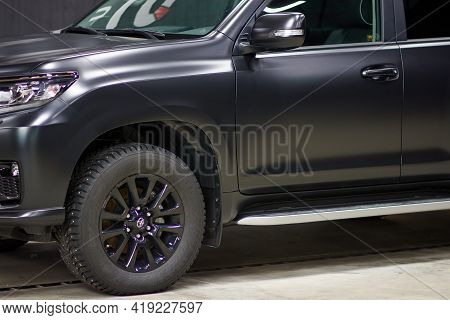 The Toyota Land Cruiser Car Covered With A Protective Paint And Varnish Matte Film Of Black Color Is