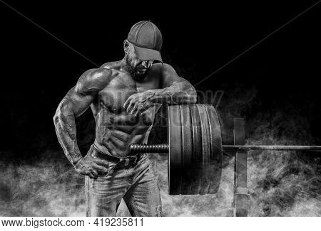 Muscular Bearded Man Stands Near The Barbell. Bodybuilding, Fitness, Powerlifting Concept.